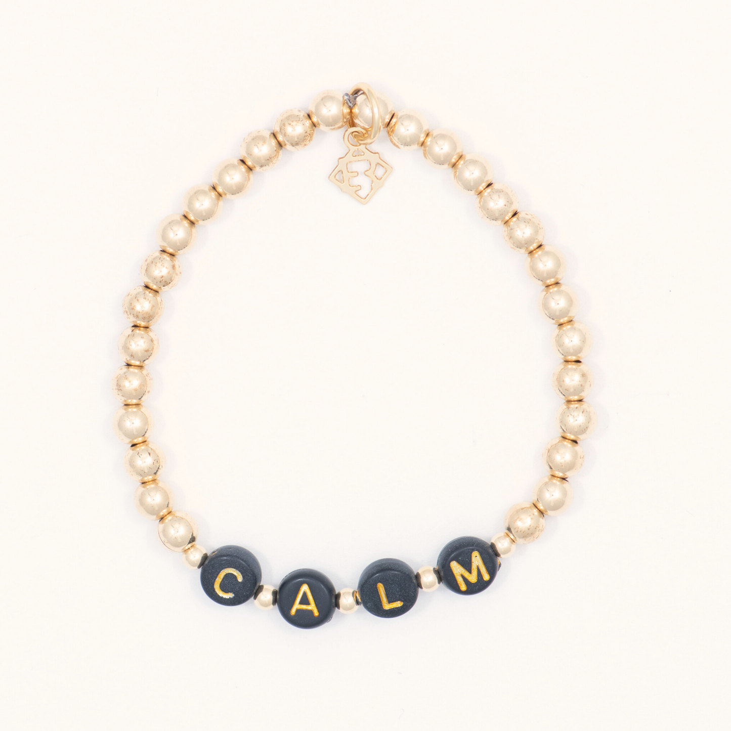 Beaded bracelet with black beads displaying 'CALM' on a white background