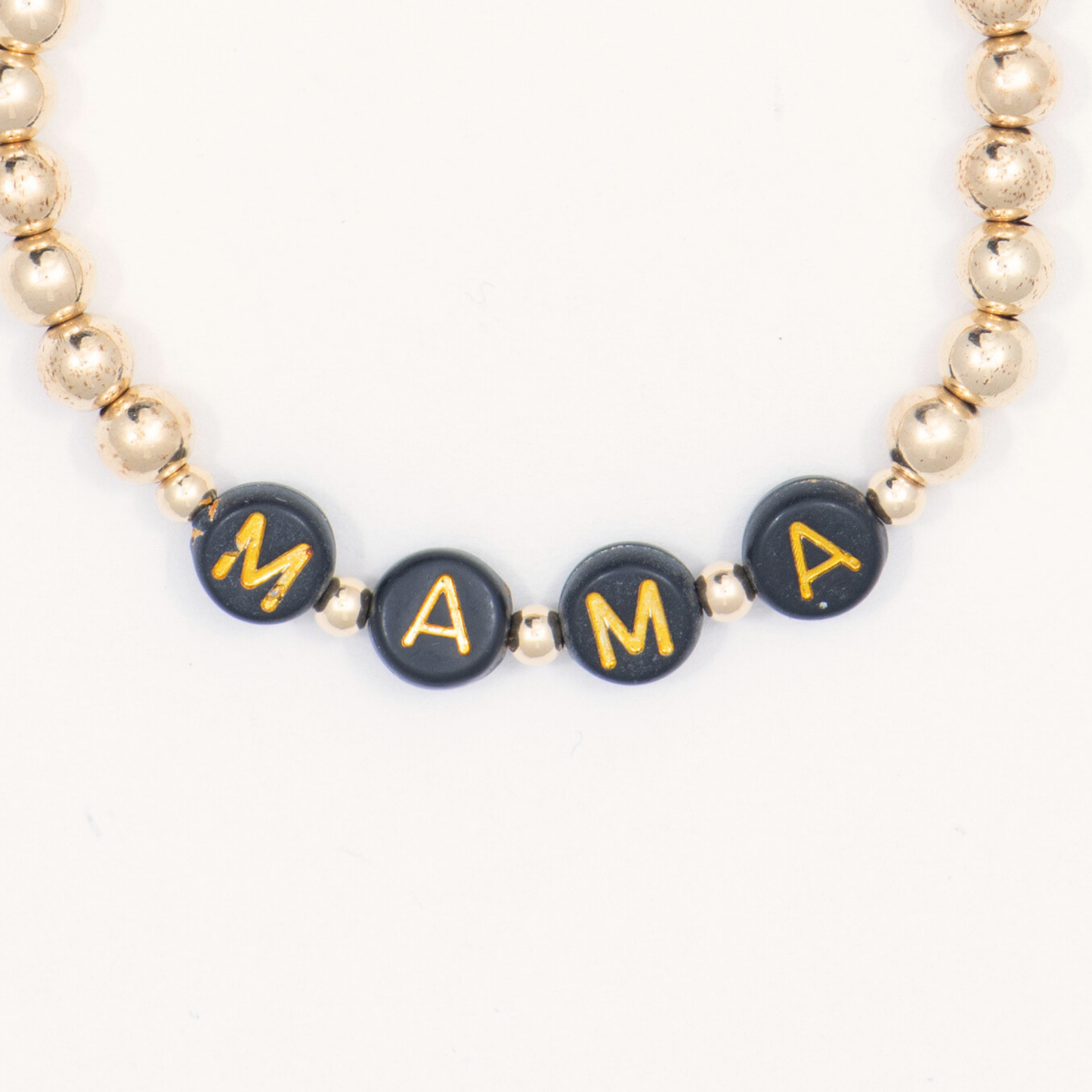 Bracelet with 'MAMA' beads on a white background