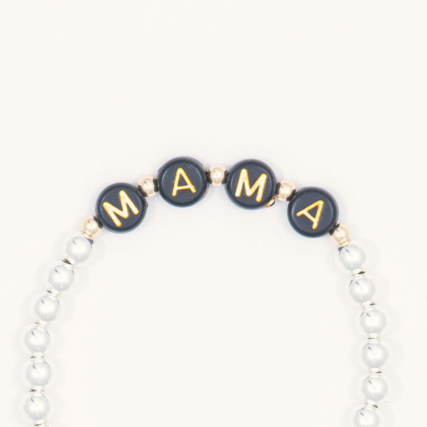 Bracelet with 'MAMA' beads on a white background