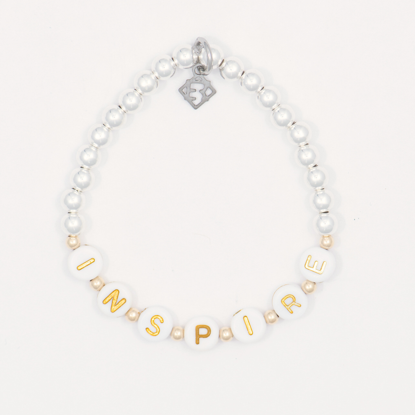 Bracelet with gold letter beads spelling 'INSPIRE' on a white background