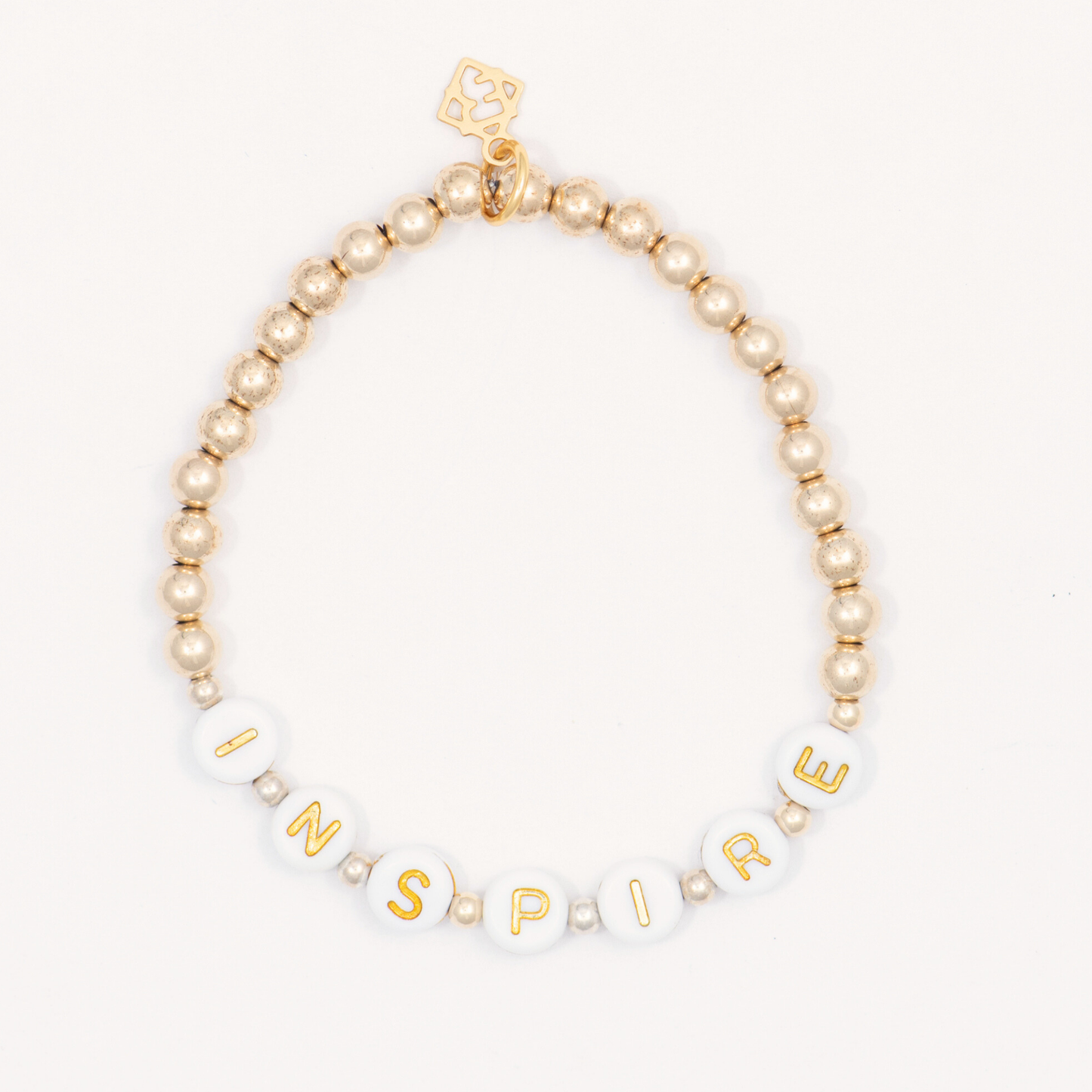 Beaded bracelet with gold letter beads spelling 'INSPIRE' on a white background