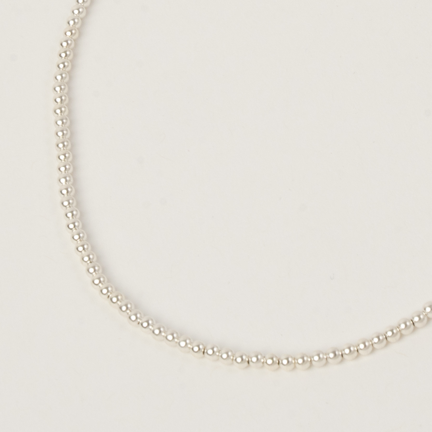 Pearl necklace on a light gray background