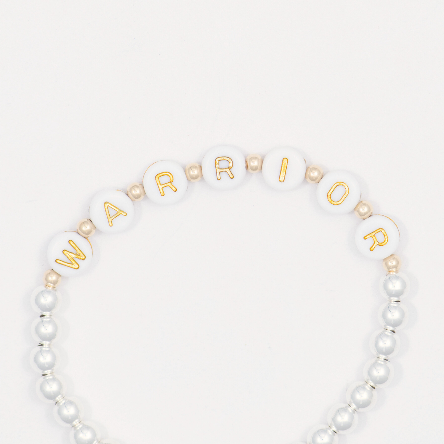 Beaded bracelet with gold lettering spelling 'WARRIOR' on a white background