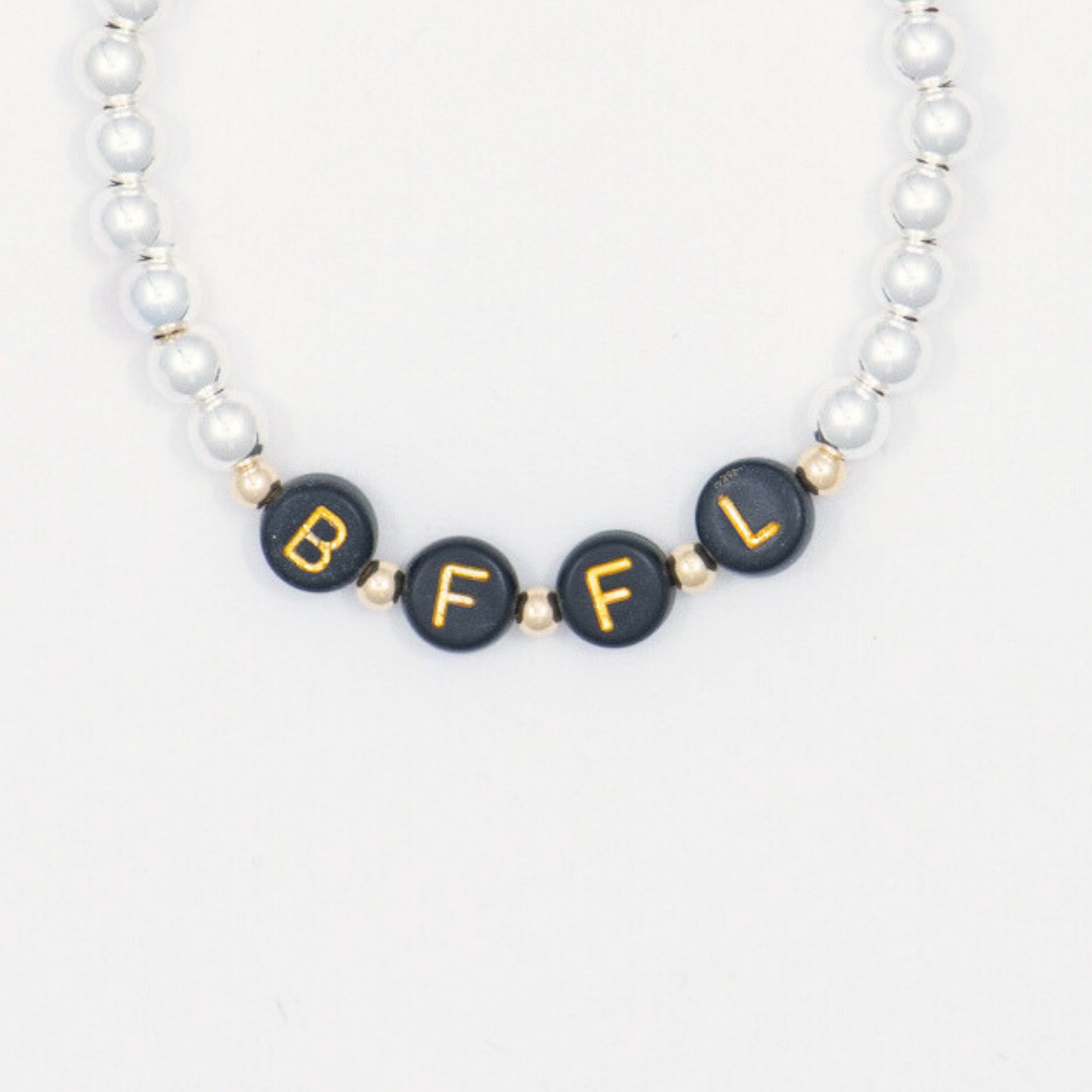 Bracelet with black beads featuring gold letters on a white background
