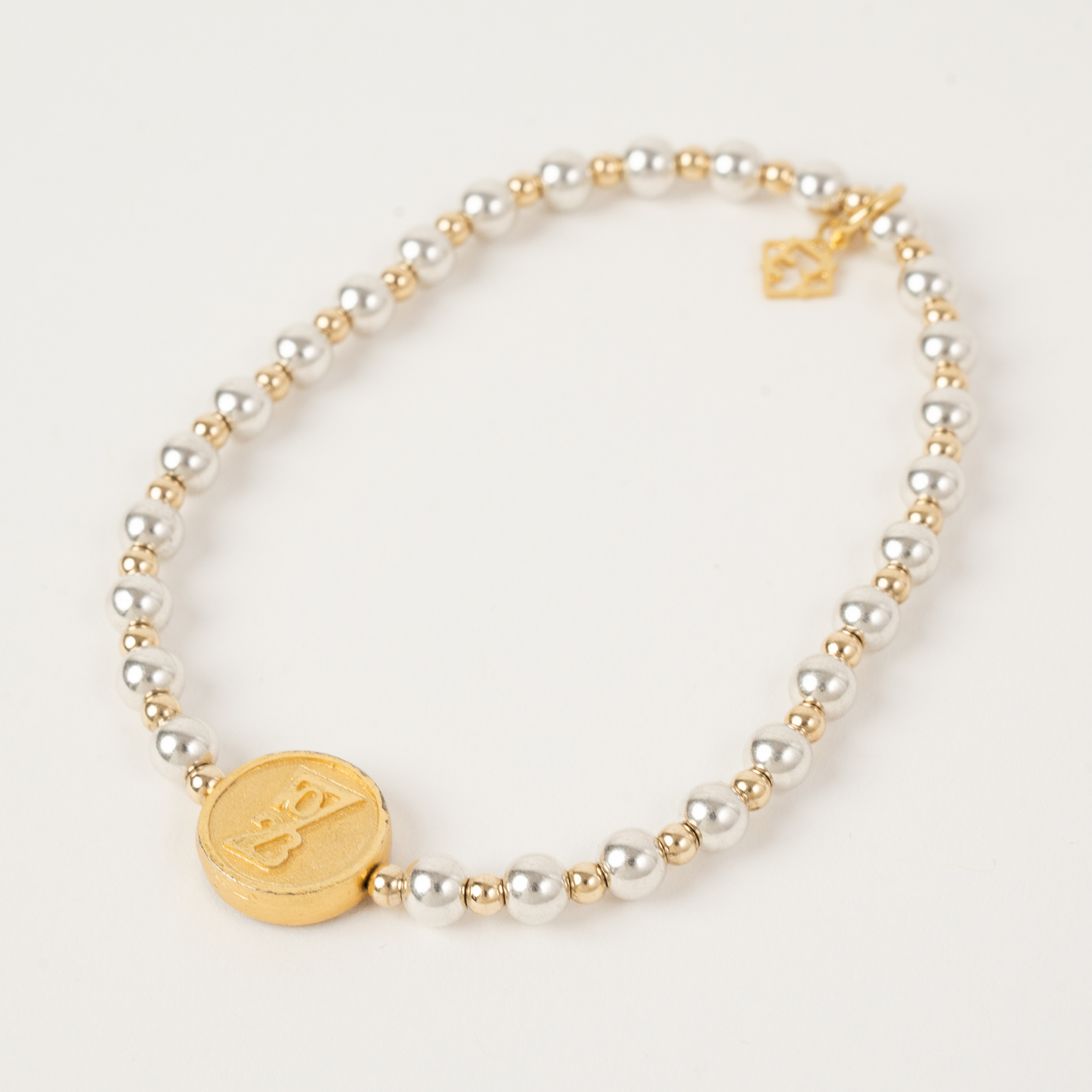 Pearl and gold bracelet on a light background
