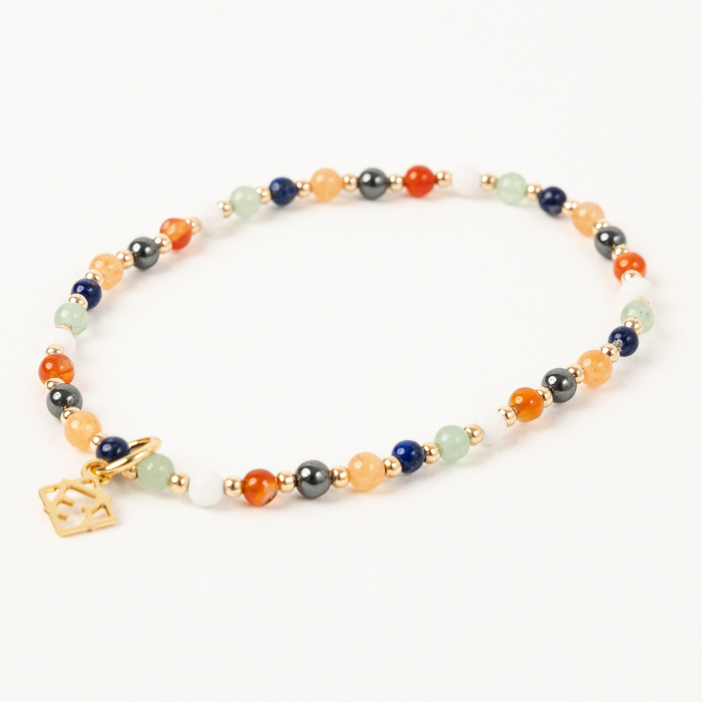 Multicolored beaded necklace with a gold charm on a white background