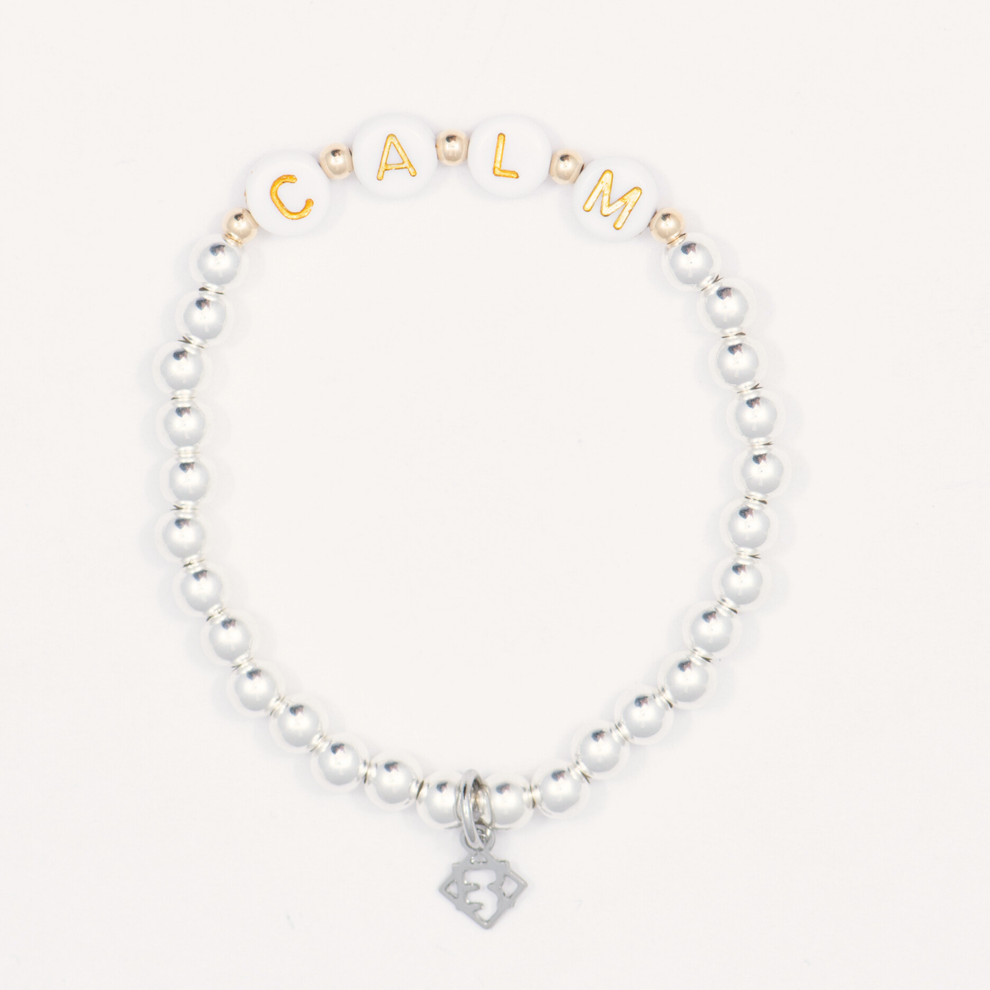 Beaded bracelet with gold letter beads spelling 'CALM' on a white background