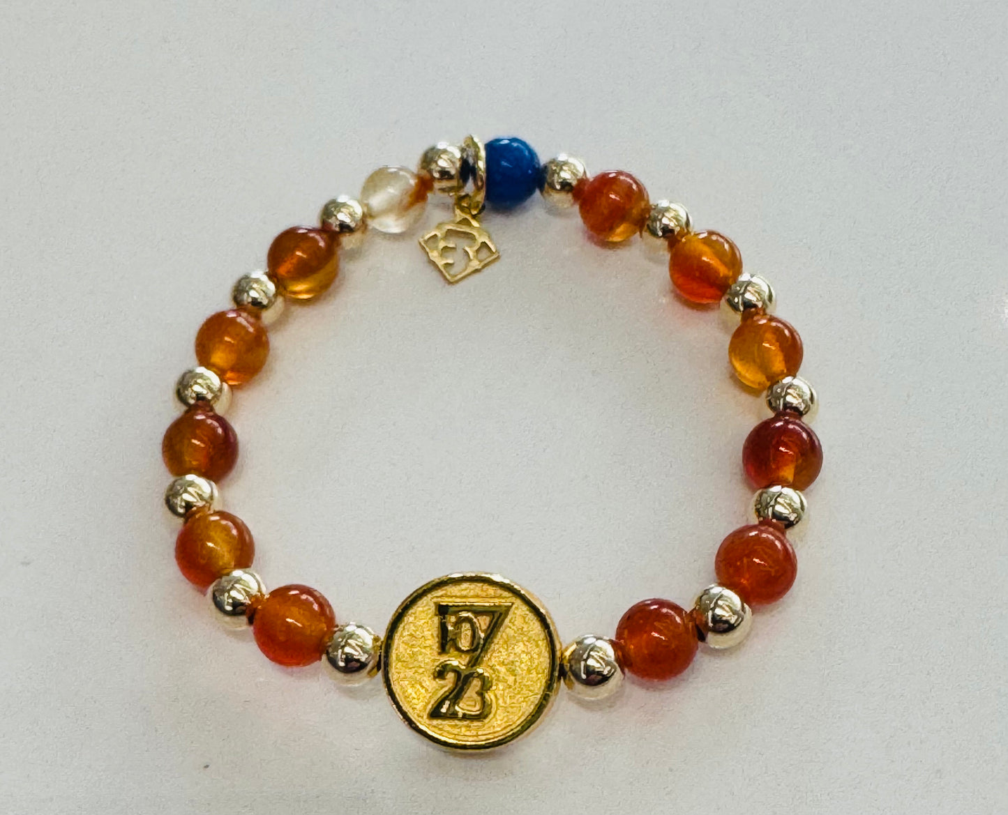 Multicolored beaded bracelet with gold charm