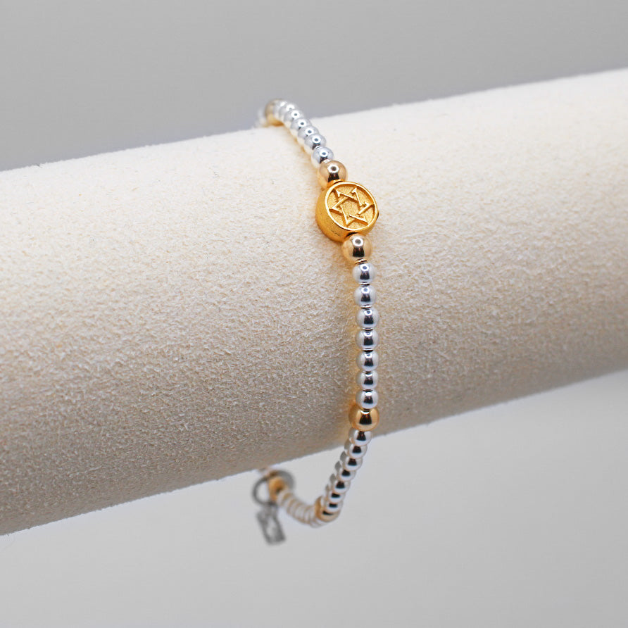 silver bracelet with gold star accent charms