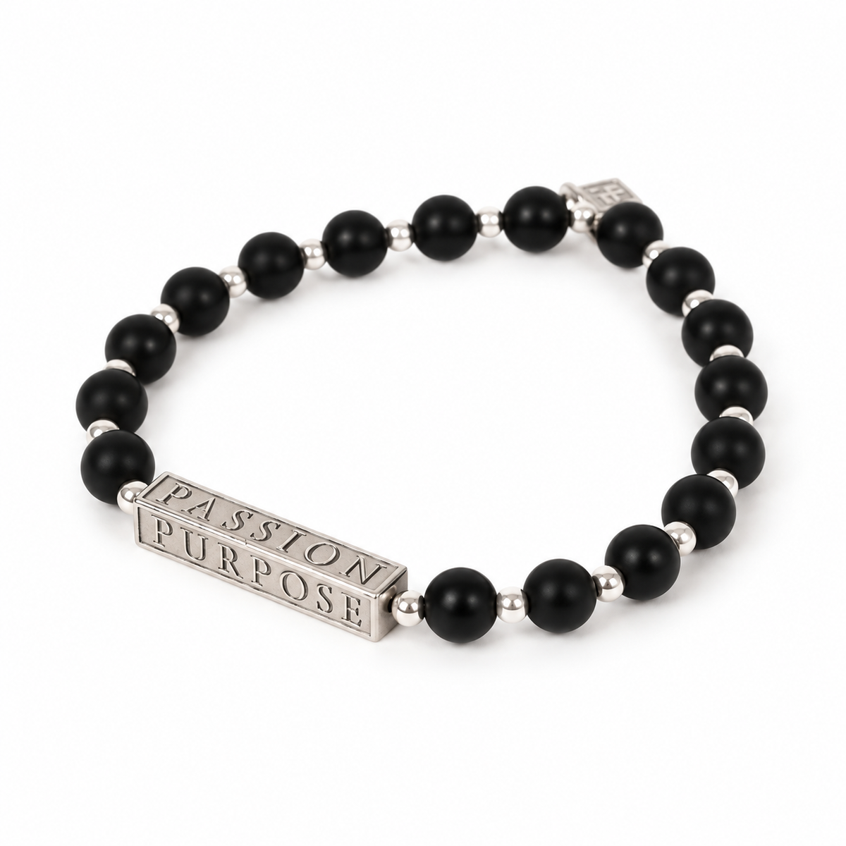 A beaded stretch bracelet featuring matte black round beads separated by small silver spacer beads, with a rectangular silver charm engraved with the words 'PASSION PURPOSE'.