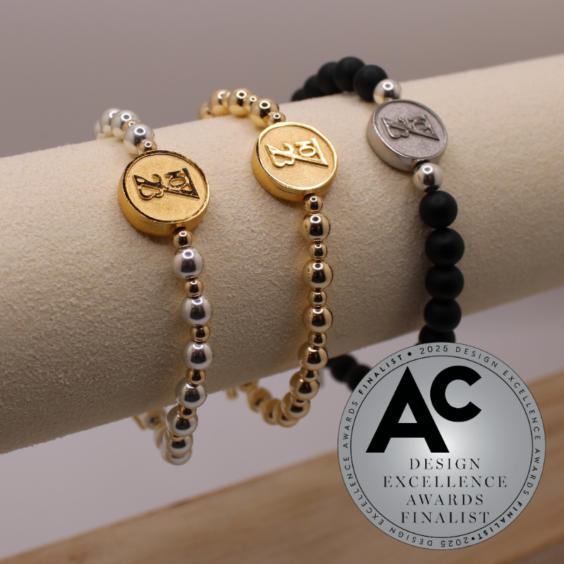 Three beaded bracelets on a mannequin arm with a Design Excellence Awards Finalist badge.