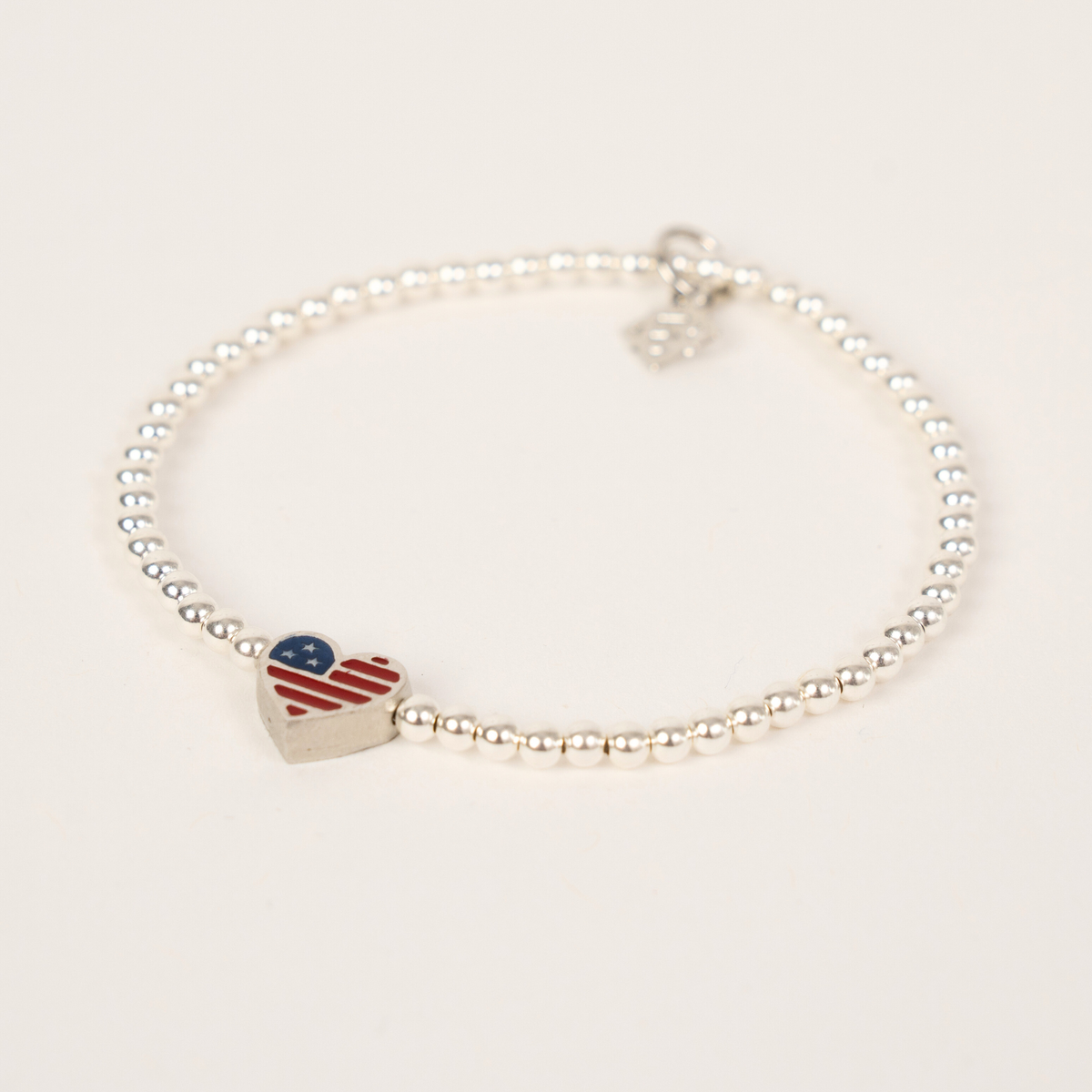 America250 Happy Heart Bracelet with 3mm silver-filled beads, a patriotic enamel heart and silver ER charm