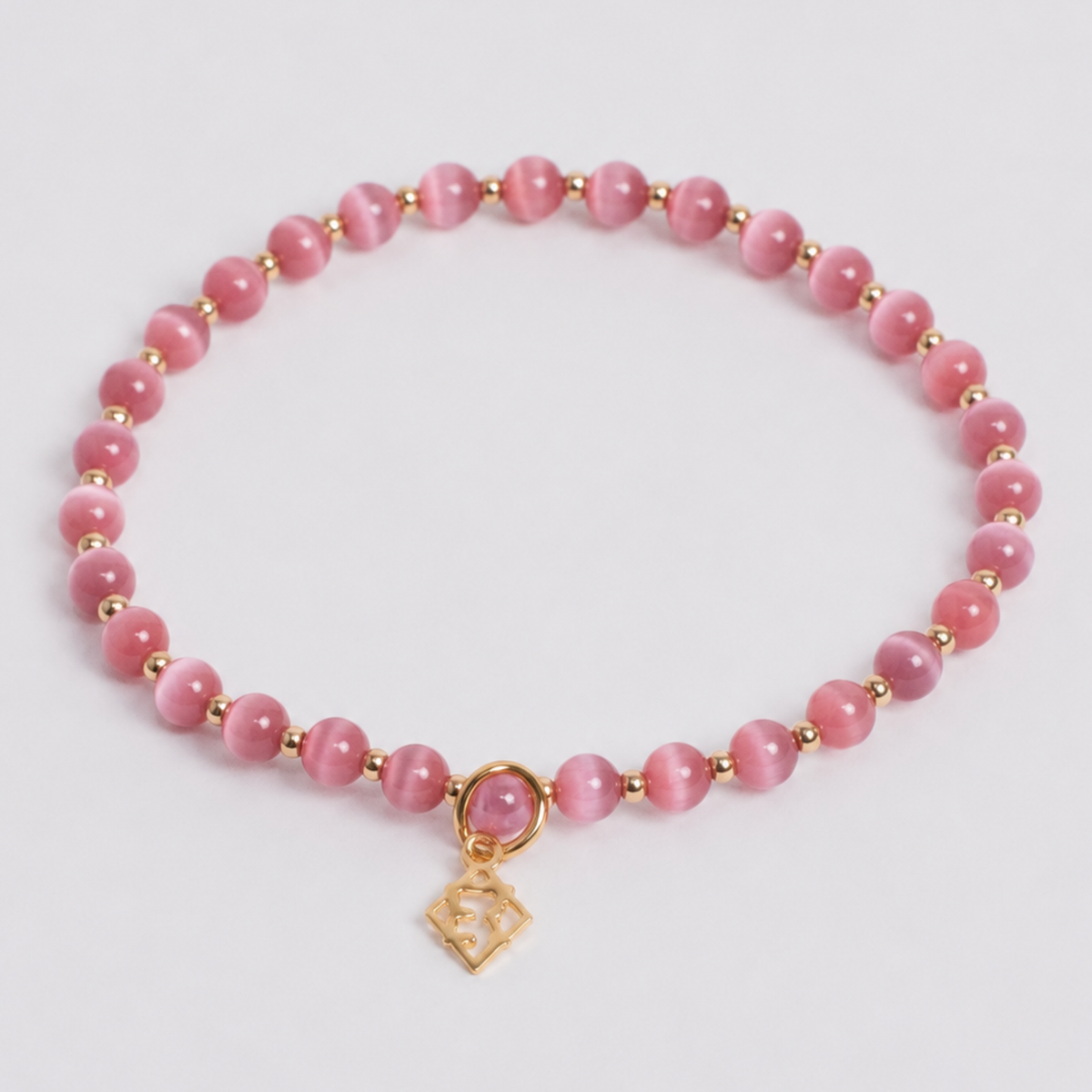Dark Pink Prism Bracelet with 4mm cat’s-eye stones, 14K gold-filled beads and a golden ER charm