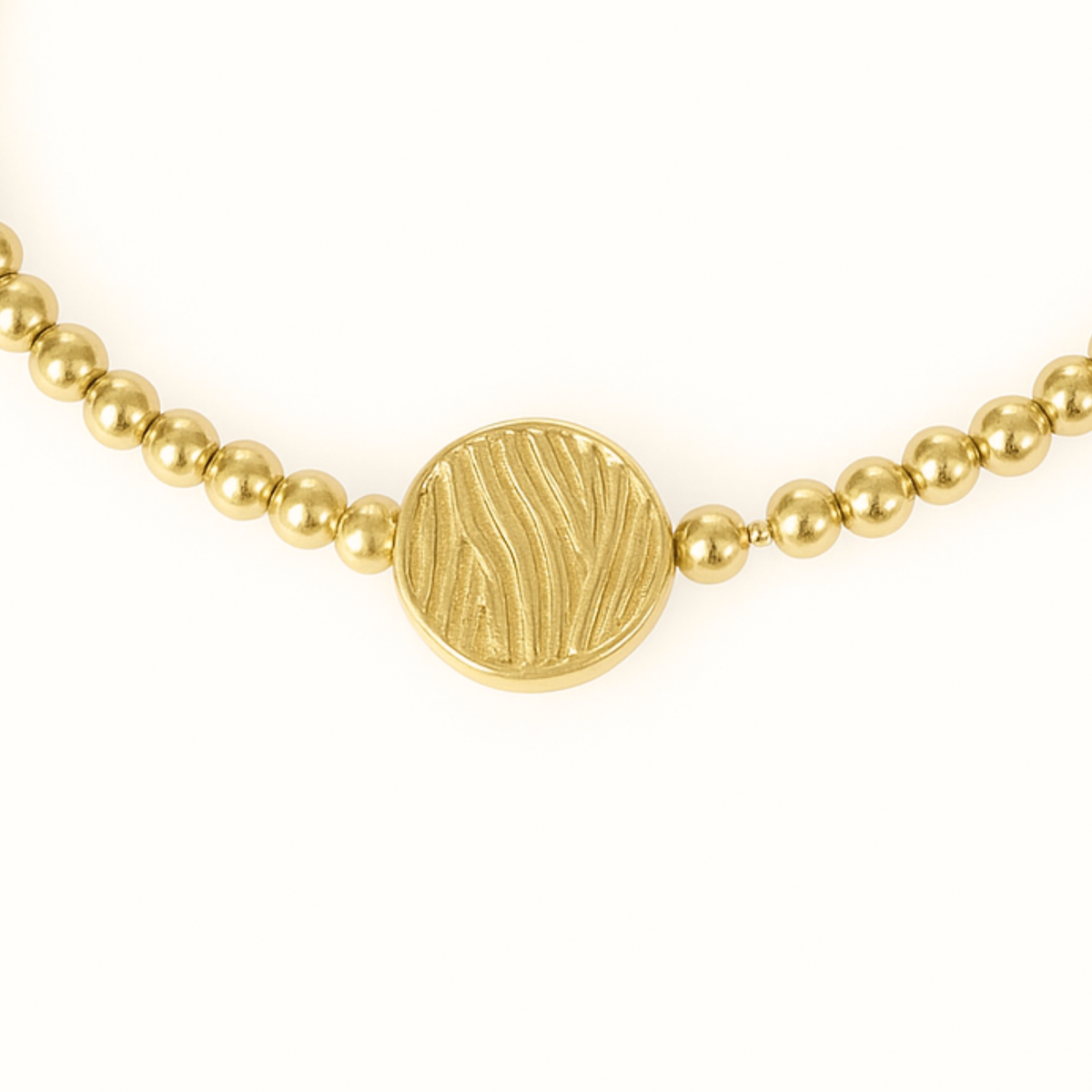 Close-up of the textured golden wave bead and 3mm 14K gold-filled beads on the S.E.A. Calming Bracelet