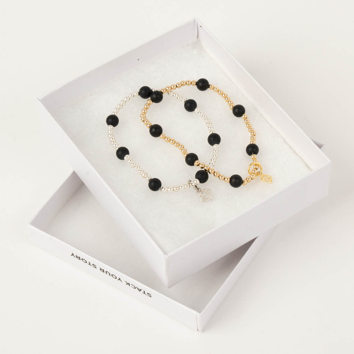 Maverick Duo with one 14K gold-filled and black onyx bracelet and one sterling silver and black onyx bracelet in an ElyseRyan gift box