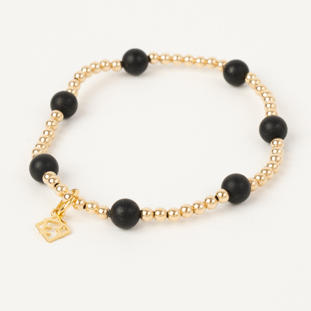 Maverick Edge Bracelet with 3mm 14K gold-filled beads, 6mm black onyx accents and an ElyseRyan charm
