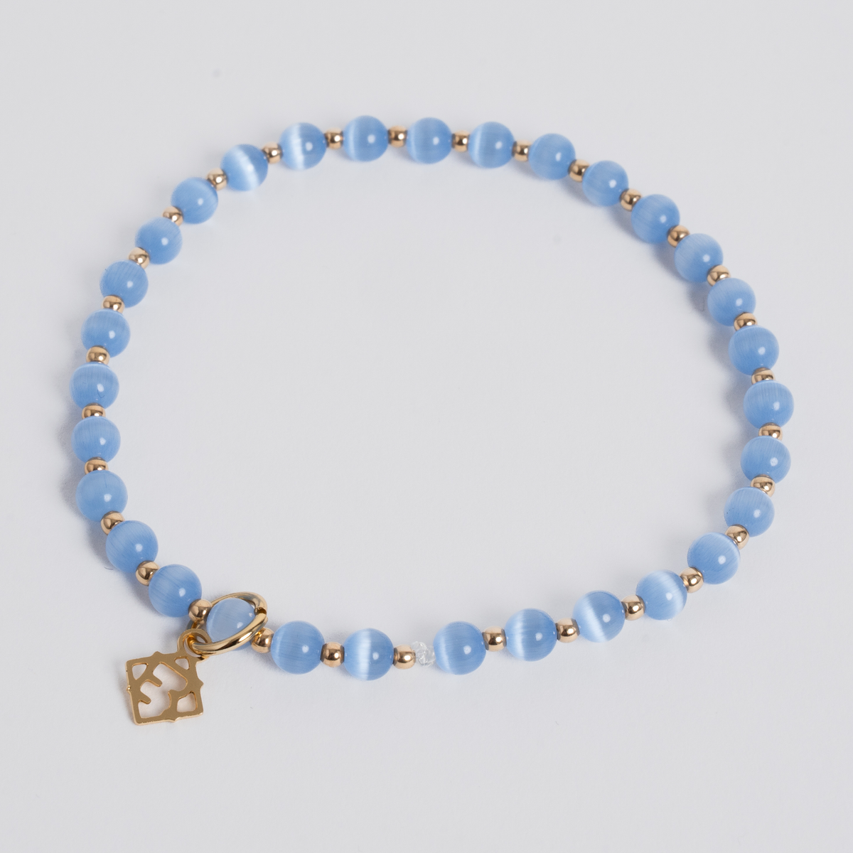 Ocean Blue Prism Bracelet with 4mm cat’s-eye stones, 14K gold-filled beads and a golden ER charm