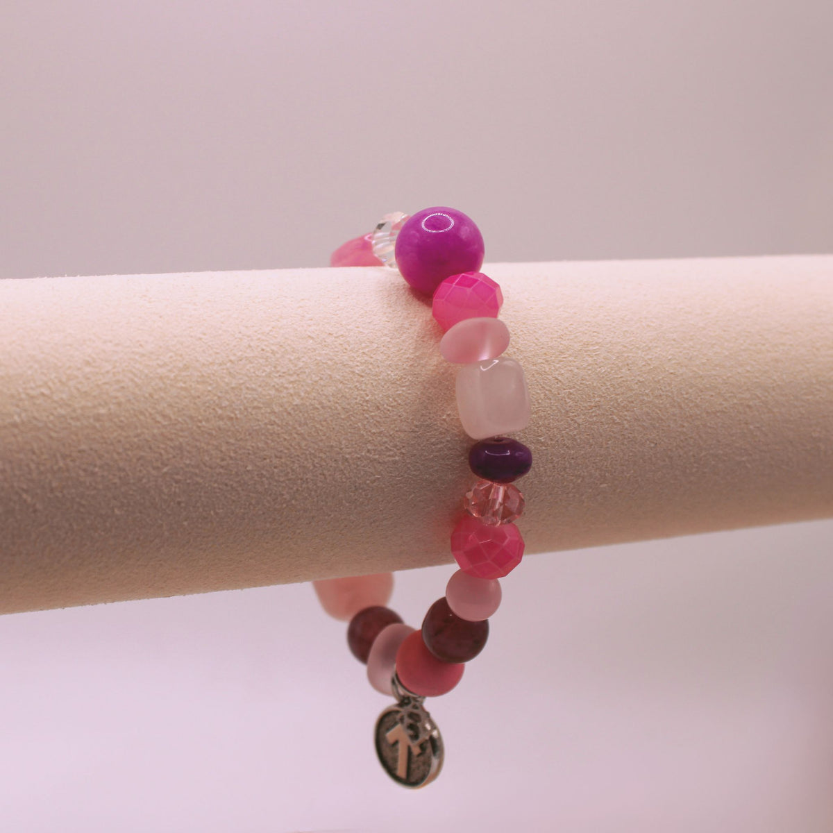 SU2C Breast Cancer Awareness Wristrock with mixed pink and purple stones, clear crystals, textured beads and an SU2C arrow charm