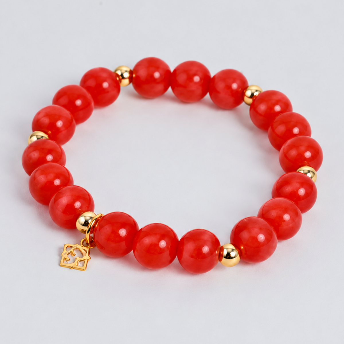 Prism Maxi Apple Red stretch bracelet with 10mm red cat’s-eye beads, 5mm 14K gold-filled accents and a signature golden ER charm