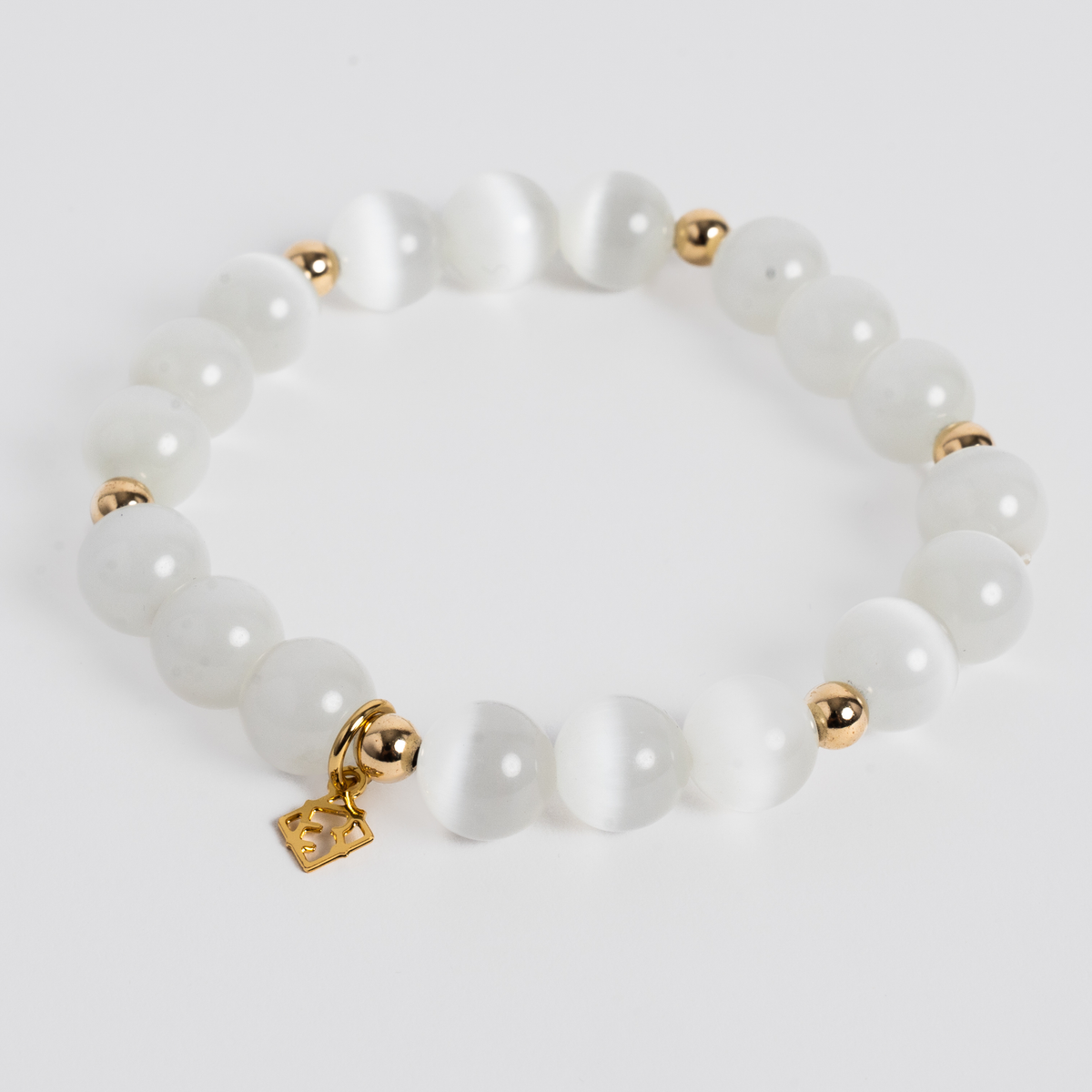 Prism Maxi Cloud White stretch bracelet with 10mm white cat’s-eye beads, 5mm 14K gold-filled accents and a signature golden ER charm