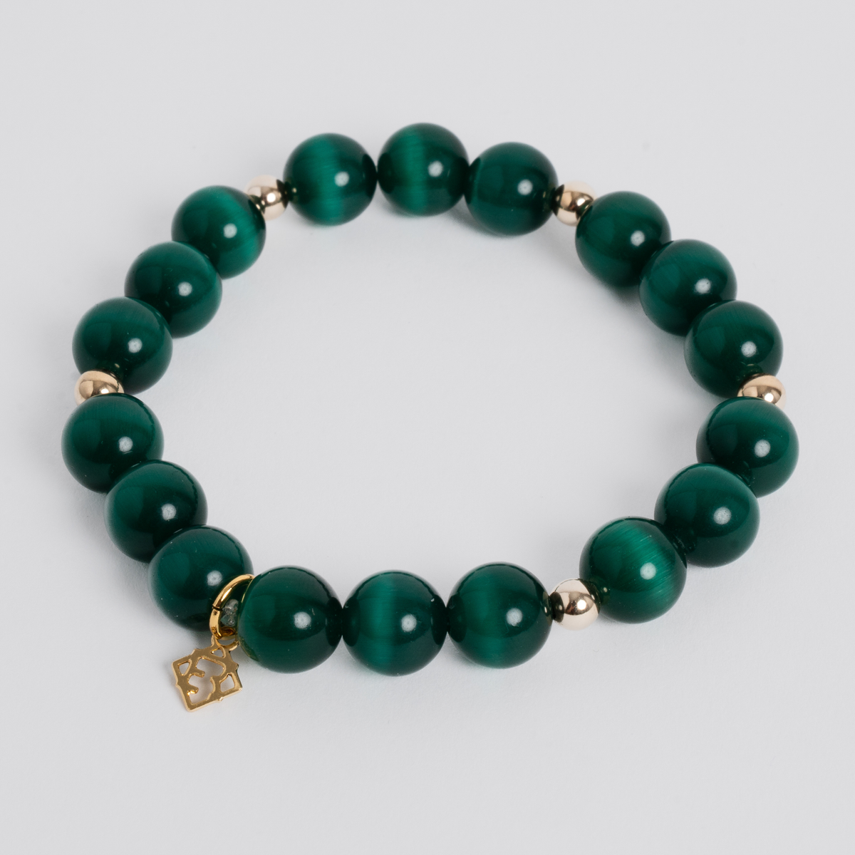 Prism Maxi Deep Green stretch bracelet with 10mm cat’s-eye beads, 5mm 14K gold-filled accents and a signature golden ER charm
