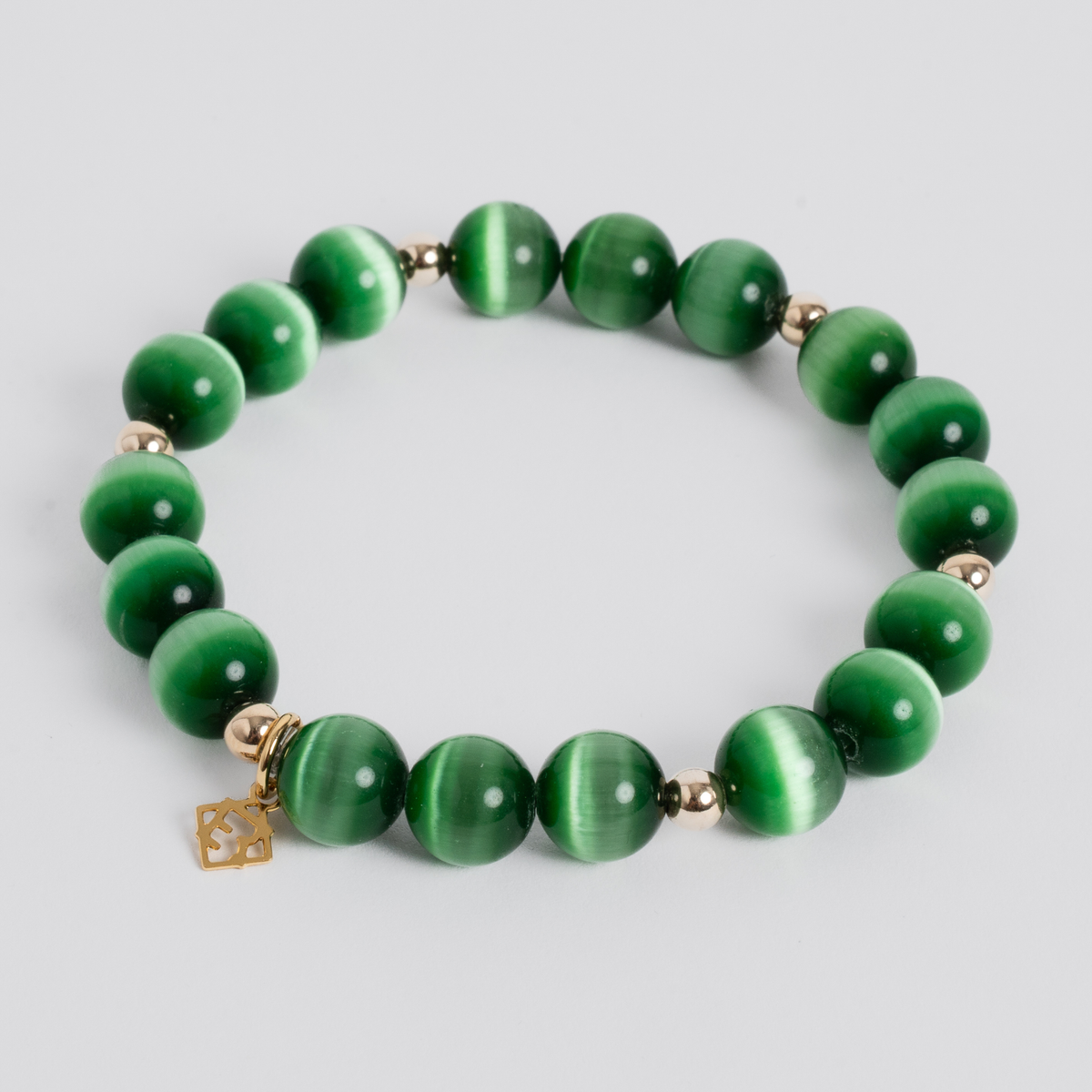 Prism Maxi Evergreen stretch bracelet with 10mm green cat’s-eye beads, 14K gold-filled beads and a golden ER charm