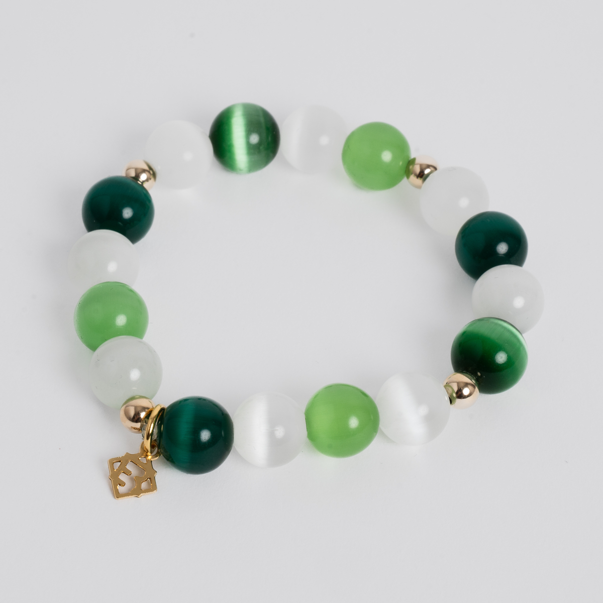 Prism Maxi Multi Greens stretch bracelet with 10mm green cat’s-eye beads, 14K 5mm gold-filled accents and a signature golden ER charm