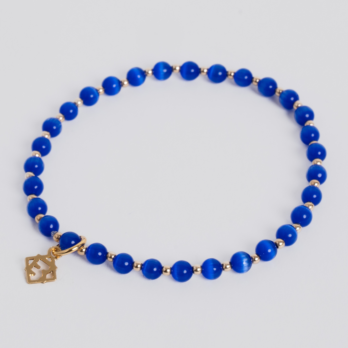 Prism Royal Blue stretch bracelet with 4mm cat’s-eye beads, 2mm 14K gold-filled accents and a signature golden ER charm