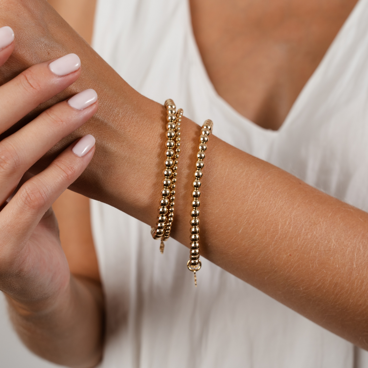 Simplicity Bold Bracelet Stack with three 14K gold-filled beaded bracelets in 3mm and 5mm sizes worn together