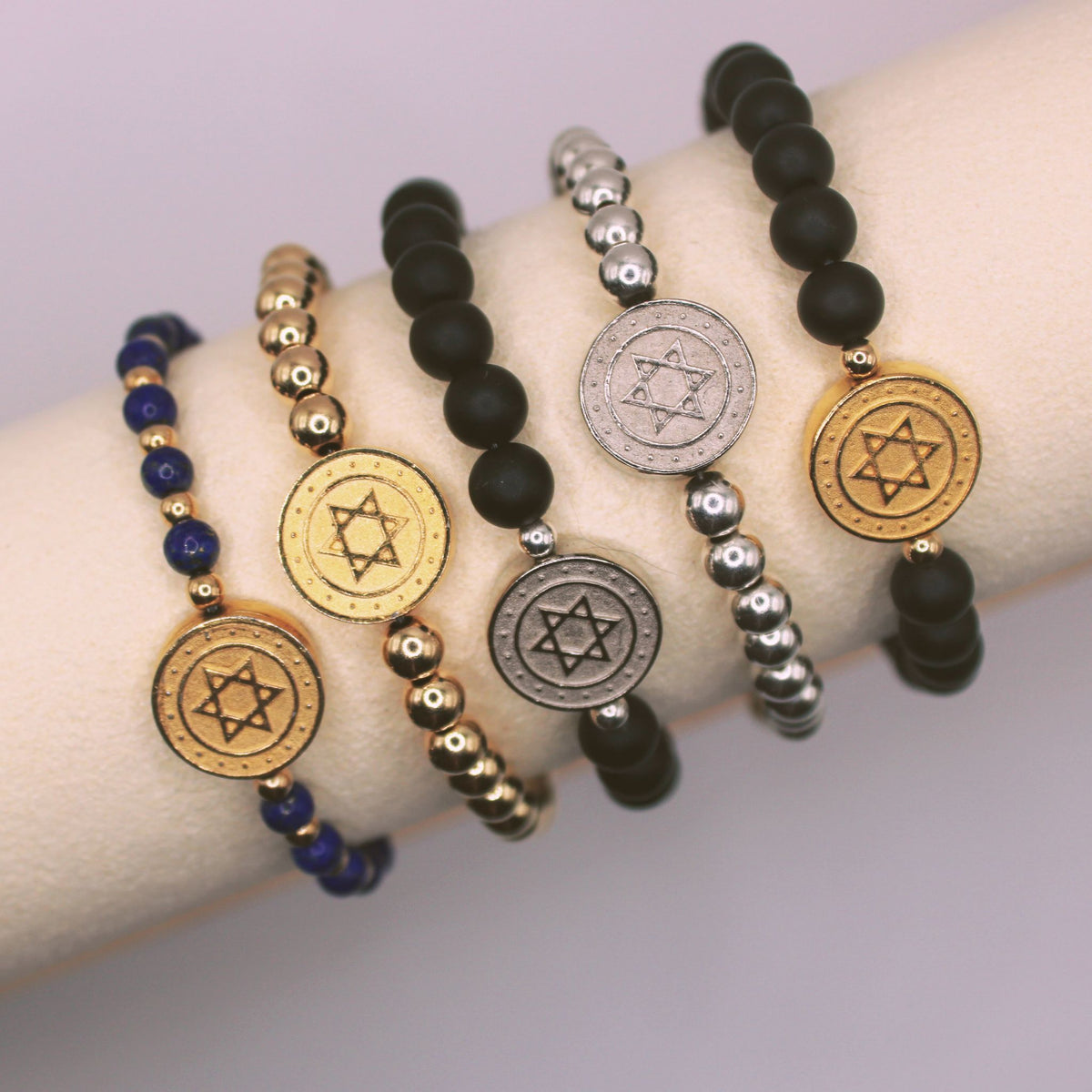 Stand with Israel Star of David bracelets in lapis, 14K gold-filled, sterling silver and matte black finishes worn together