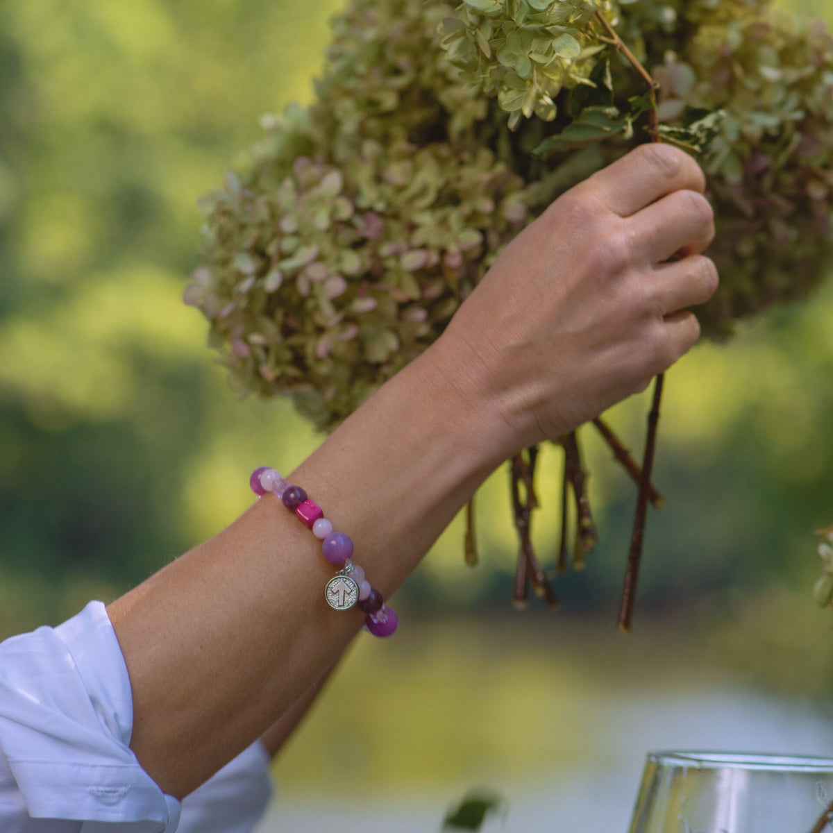 Model wearing the SU2C Breast Cancer Awareness Wristrock with mixed pink stones, crystals and a signature SU2C charm