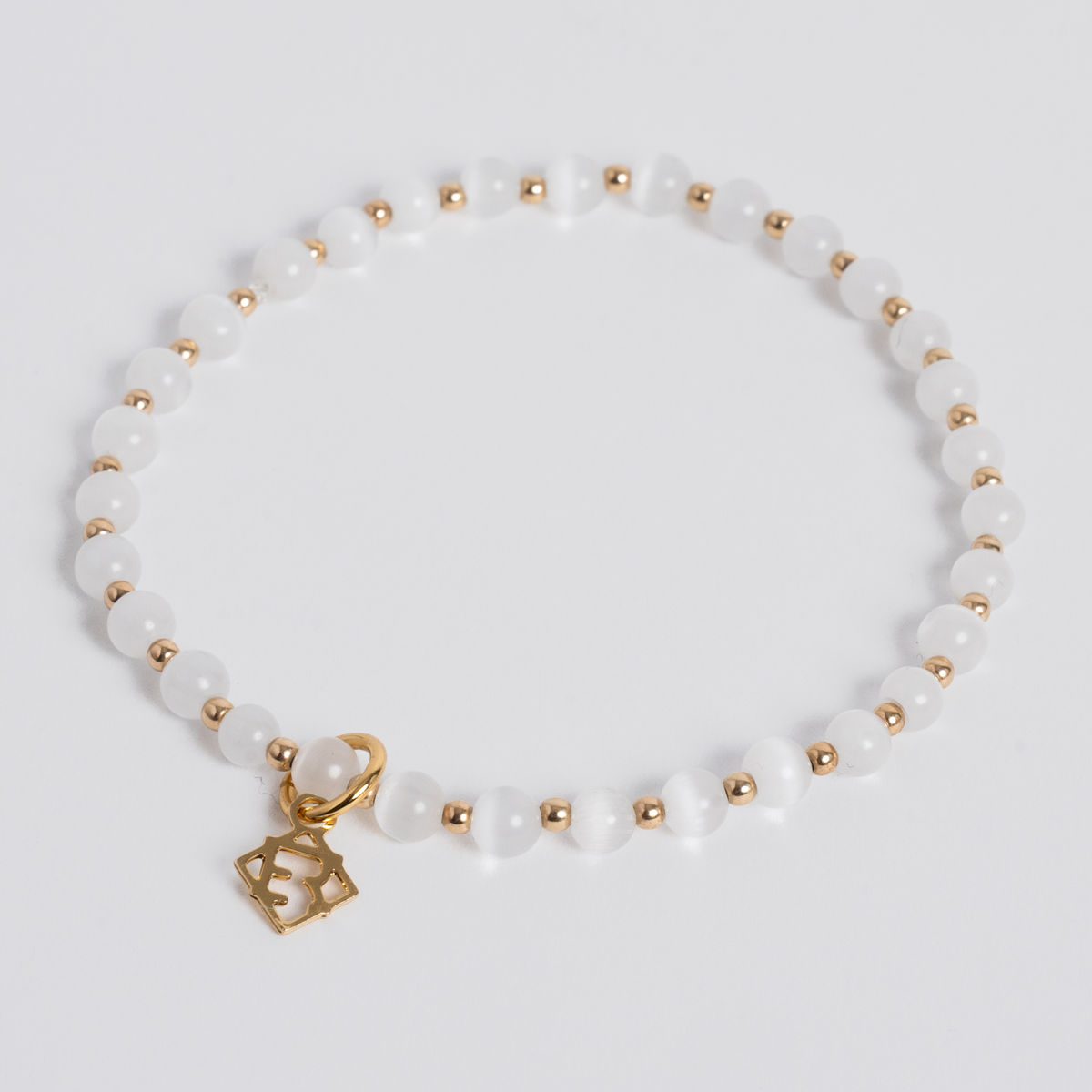 White Prism Bracelet with 4mm luminous cat’s-eye stones, 14K gold-filled beads and a golden ER charm