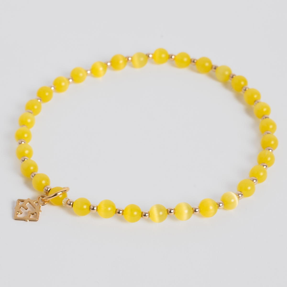Prism Sun Yellow stretch bracelet with 4mm cat’s-eye beads, 2mm 14K gold-filled accents and a signature golden ER charm