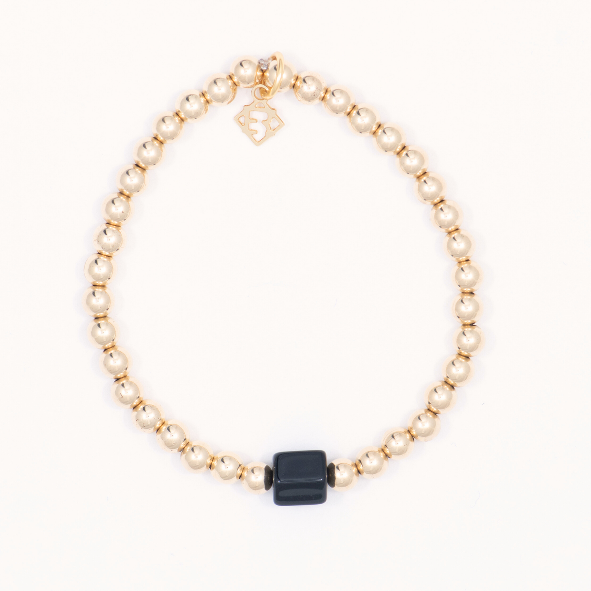 Nugget Single Bracelet with gold-filled beads, a black onyx centerpiece and ElyseRyan charm