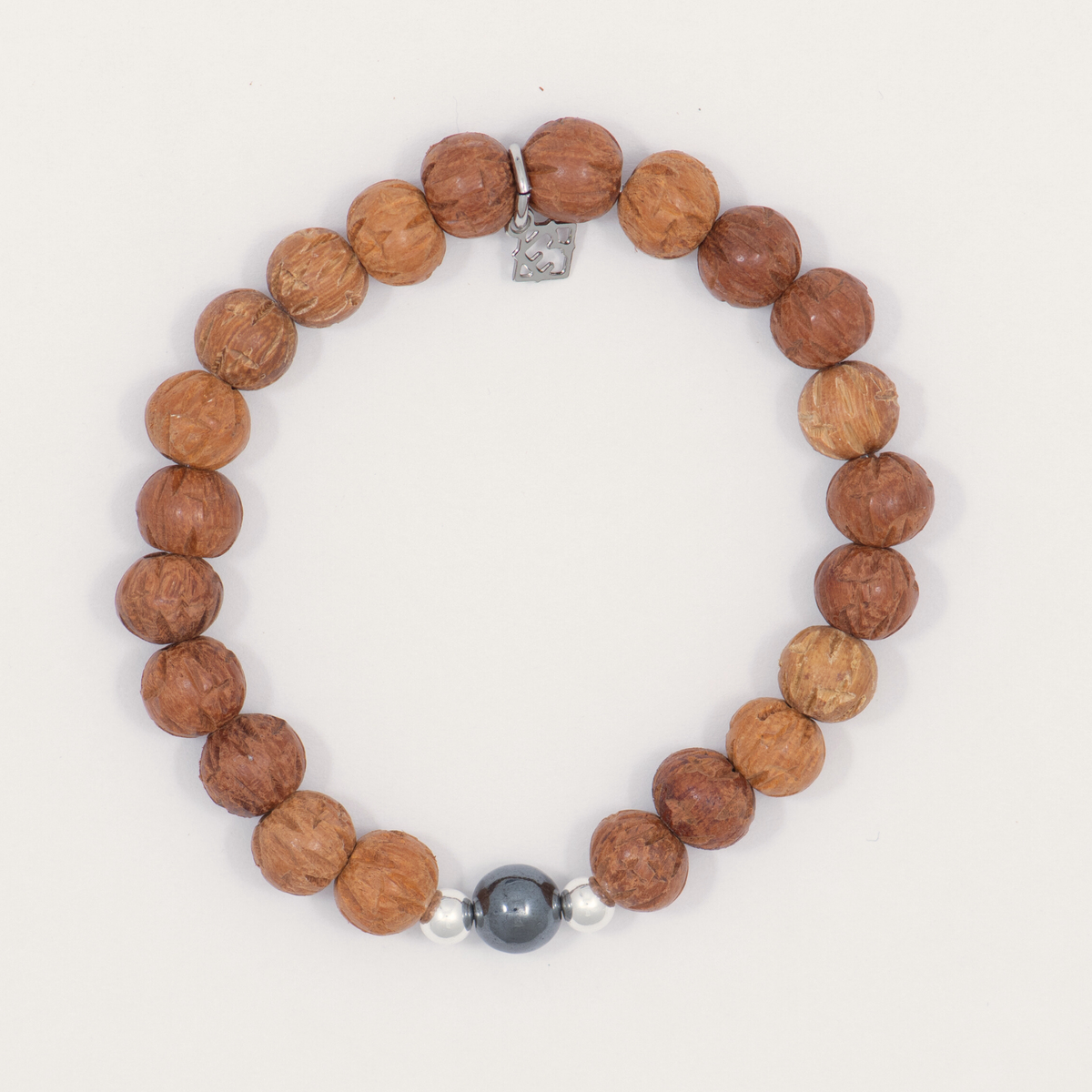 Resolute & Rooted men’s carved wood bracelet with sterling silver accents and a signature charm