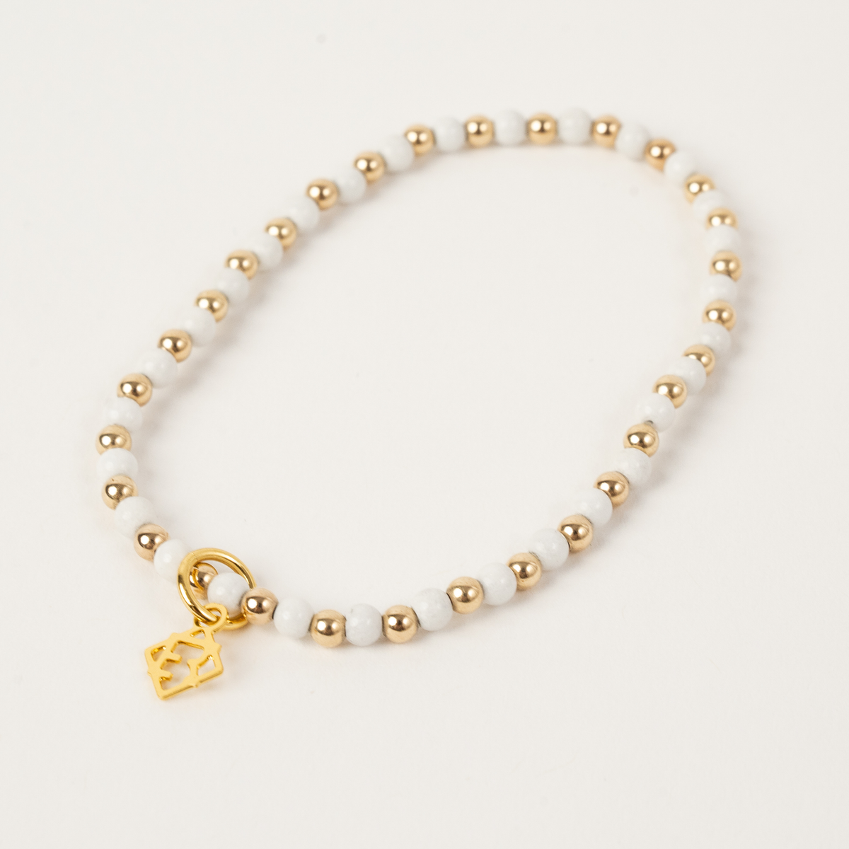 White jade stretch bracelet with alternating 3mm 14K gold-filled beads and an ElyseRyan charm