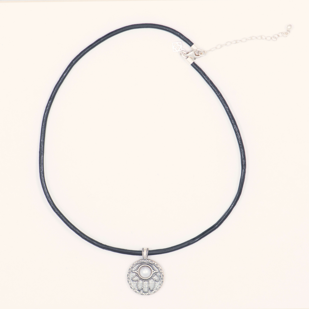Wondrous Pearl Society necklace with a pearl and sterling silver Hamsa pendant on a black leather cord with extender